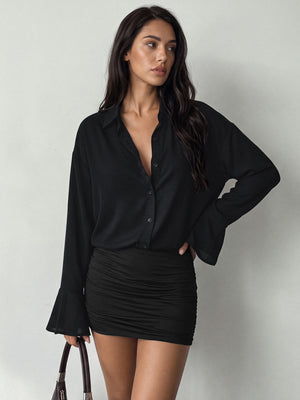 shirt dress in black featuring buttoned and bodycon fit