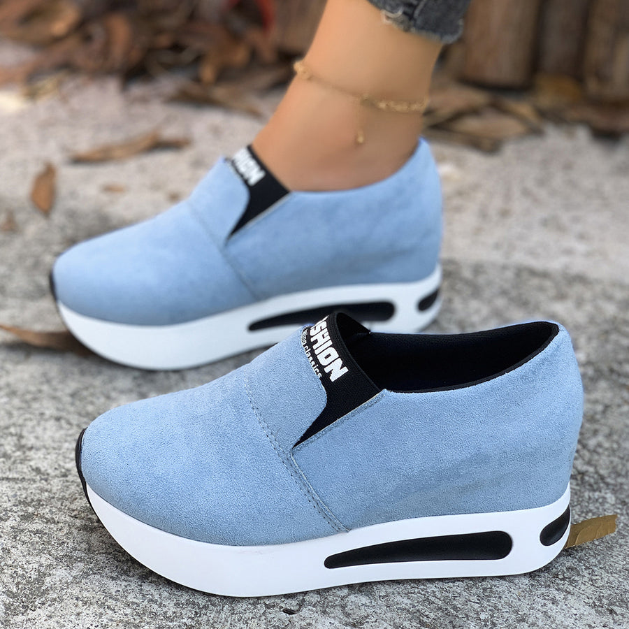 Sky blue round toe platform slip-on sneakers with white soles and black trim.