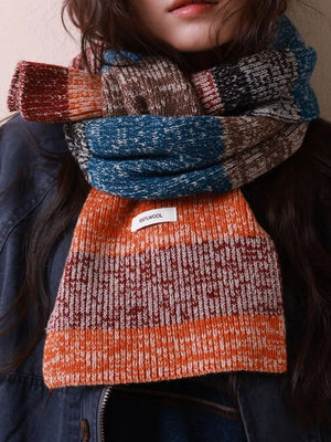Textured wool scarf with color block pattern in orange, blue, brown, and red.