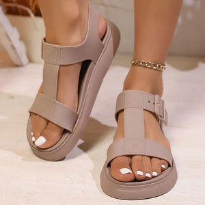 Mocha T-strap buckle platform sandals with adjustable ankle strap and gold chain anklet.