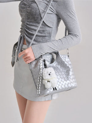silver shoulder bag featuring woven texture and geometric