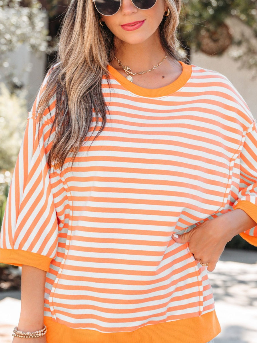Oversized orange and white striped cotton t-shirt with 3/4 sleeves and crew neck.