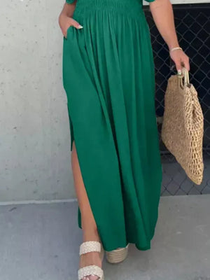 Green V-neck maxi maternity dress with smocked waist, dolman sleeves, and high side slits.