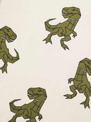 Cream cotton baby tee with geometric green dinosaur print