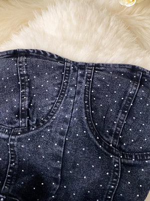 Black denim romper with allover rhinestones and pockets.