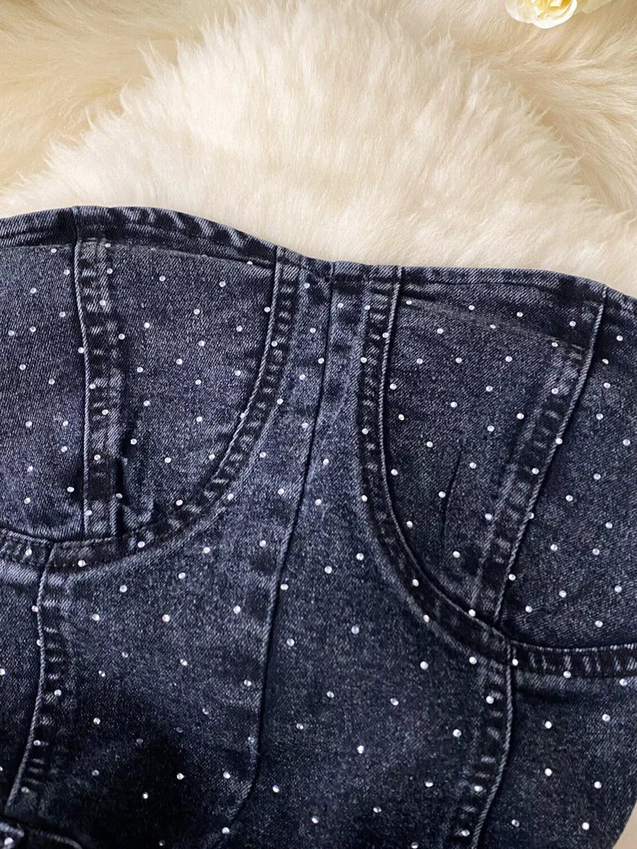Black denim romper with allover rhinestones and pockets.
