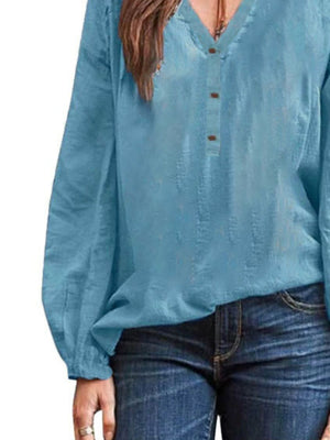 Lake blue long-sleeve blouse with notched neckline and button detail.