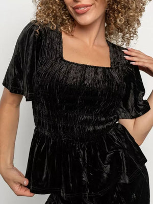 Black velvet two-piece set with square neckline, smocked bodice, and flutter sleeves.