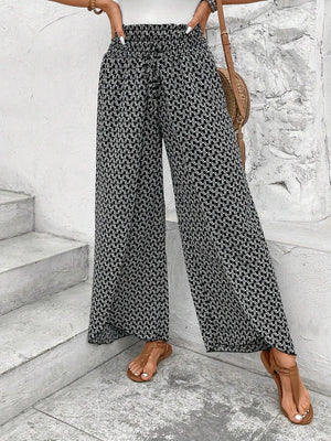 Black and white patterned palazzo pants with drawstring waist and wide legs.