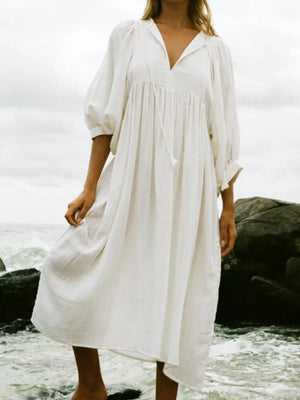 White tie-neck midi dress with puff sleeves and a gathered waist