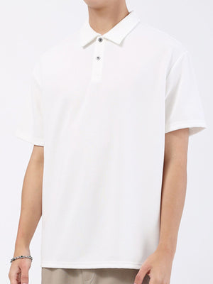 White textured performance polo shirt with short sleeves and a two-button placket.