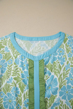 Floral ruffled maternity blouse with blue trim and green ruffles.