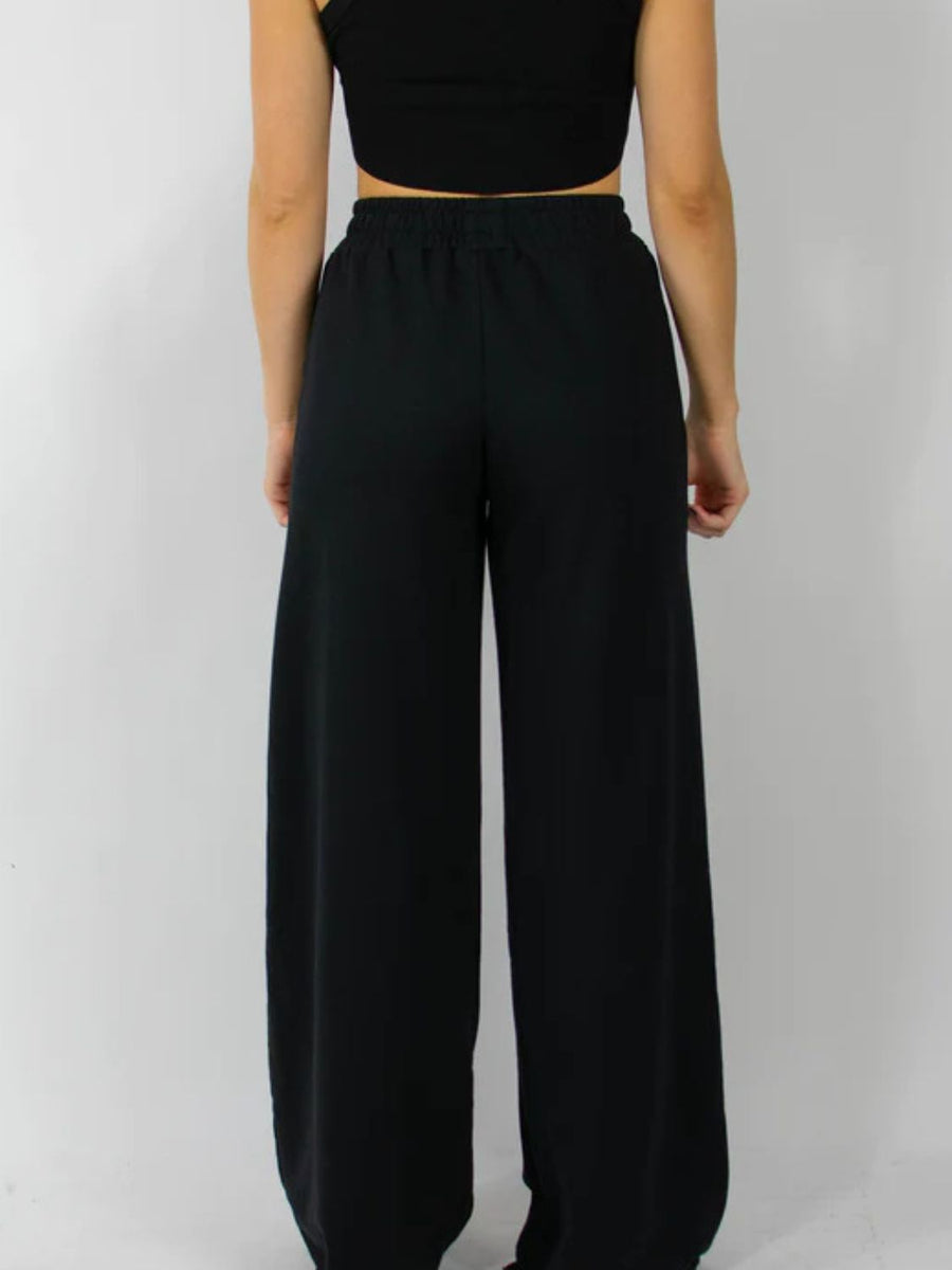 Black wide-leg lounge pants with an elastic waistband.