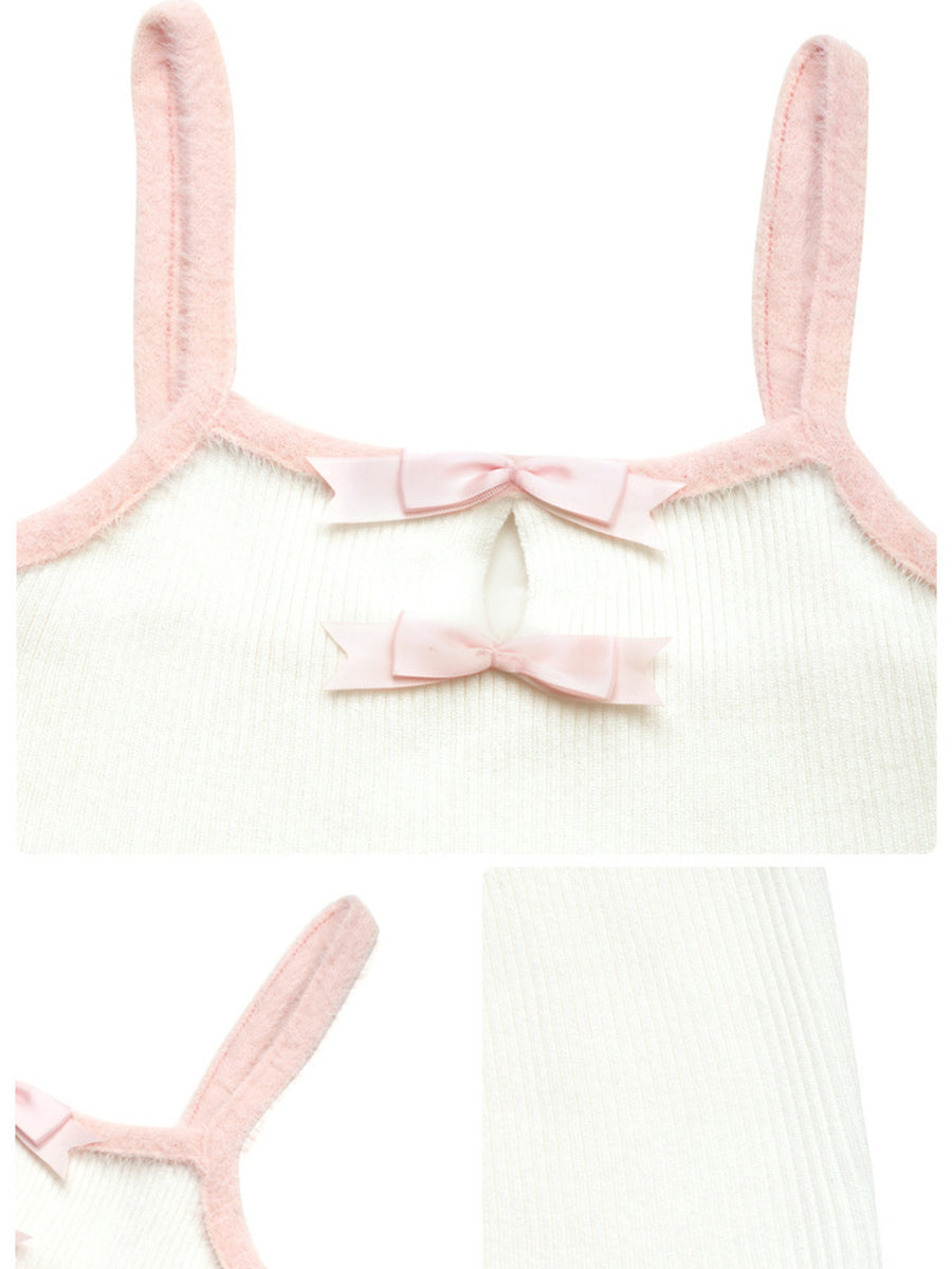 White ribbed camisole with pink trim and two pink bow accents at the neckline.