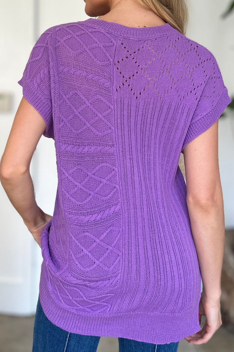Purple knit patchwork top with cable and lace details, short sleeves.