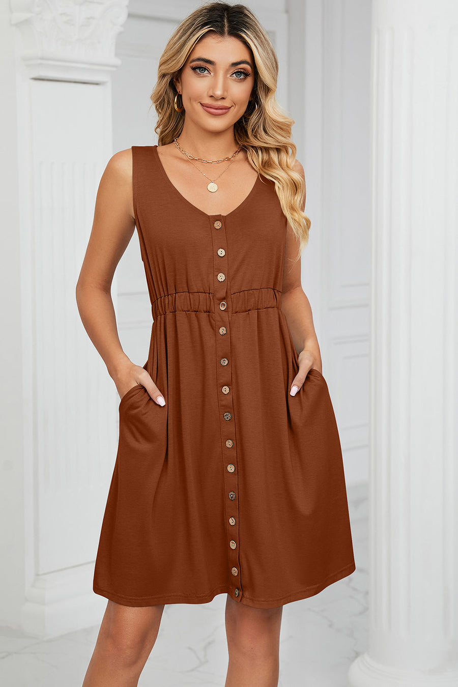 Button-down a-line summer dress in caramel with V-neck, sleeveless, elastic waist, and pockets.