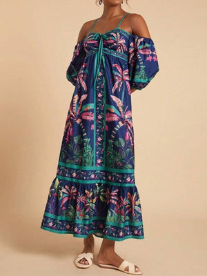 Maxi dress with tropical print, smocked bodice, tie front, and off-shoulder sleeves.