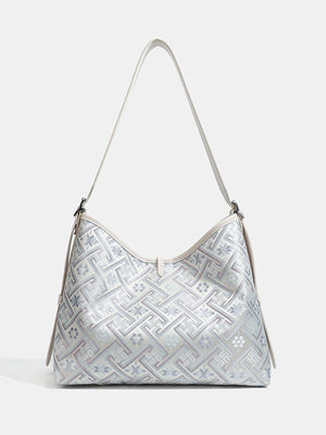 light blue handbag featuring adjustable strap and geometric
