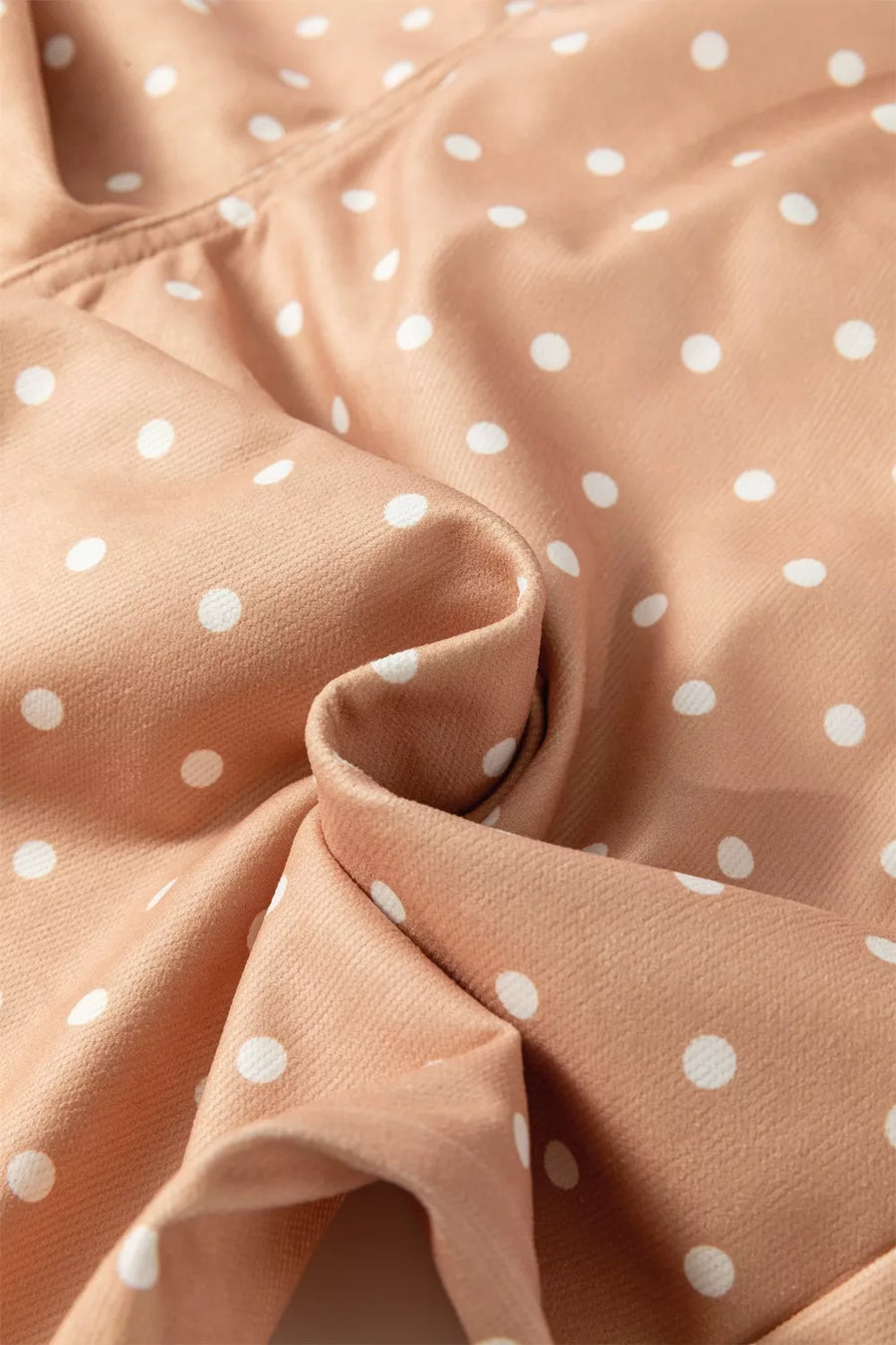 Polka dot wide-leg maternity pants in tan with white dots and drawstring detail.