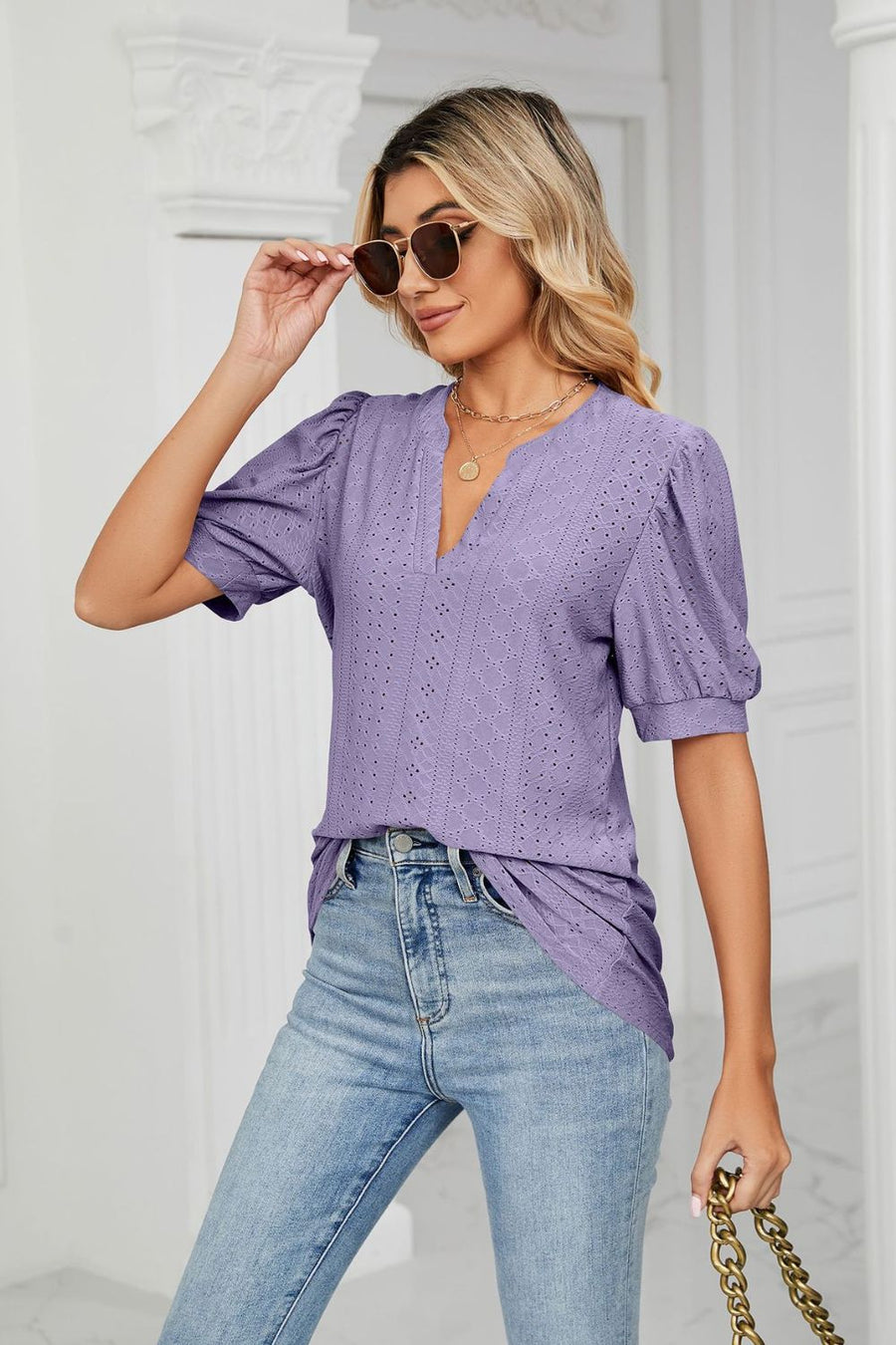 Purple perforated puff sleeve blouse with V-neck and keyhole detail.