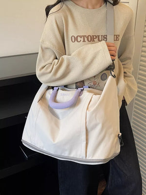 Sleek white nylon travel bag with purple handles and adjustable grey strap.