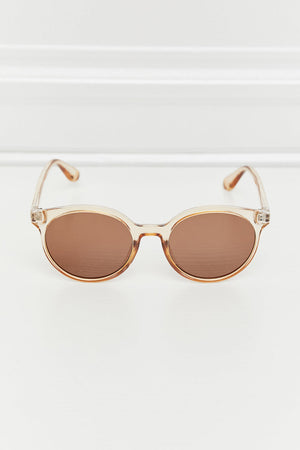 Tortoiseshell round frame sunglasses with tan translucent frames and brown lenses.