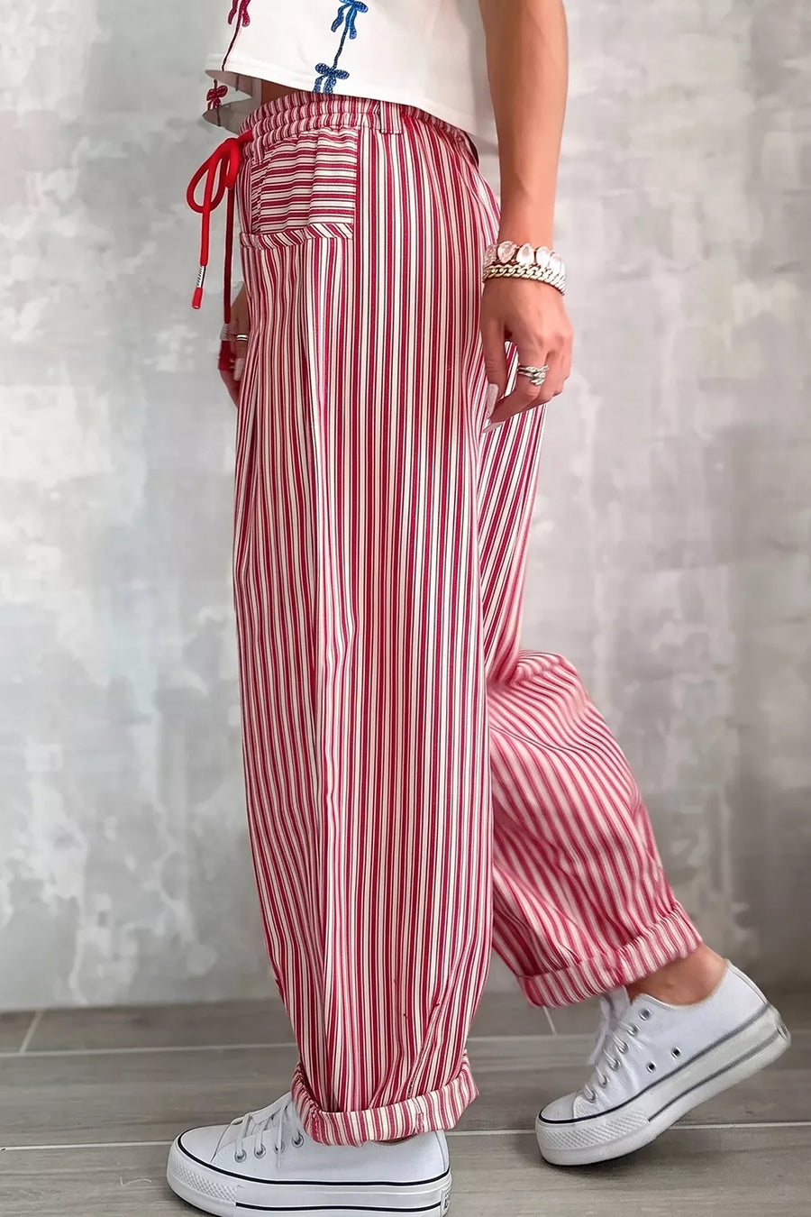 cream wide-leg pants featuring drawstring waist and striped