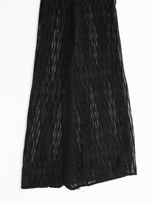 Black glitter knit mini dress with a boat neckline and backless detail.