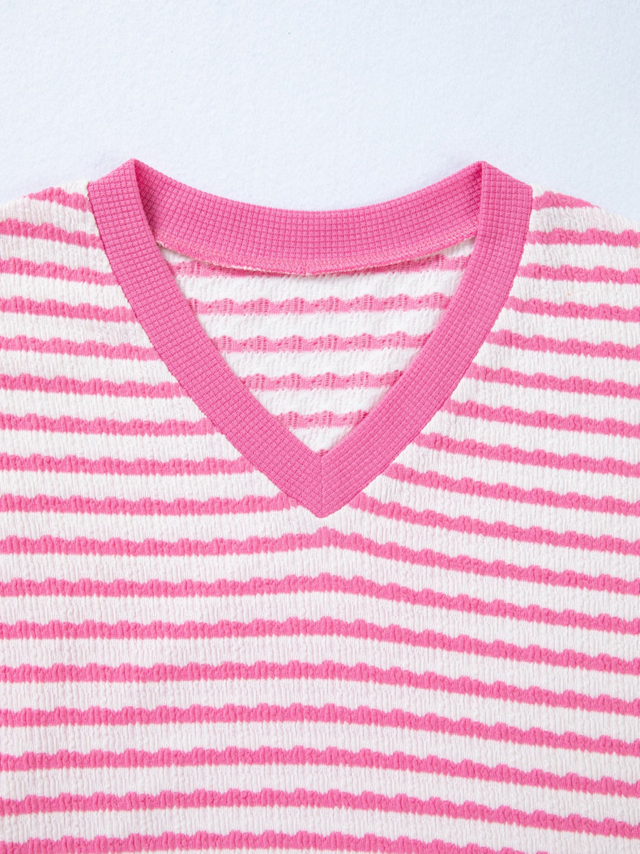 Textured V-neck t-shirt with pink and white horizontal stripes and pink trim.