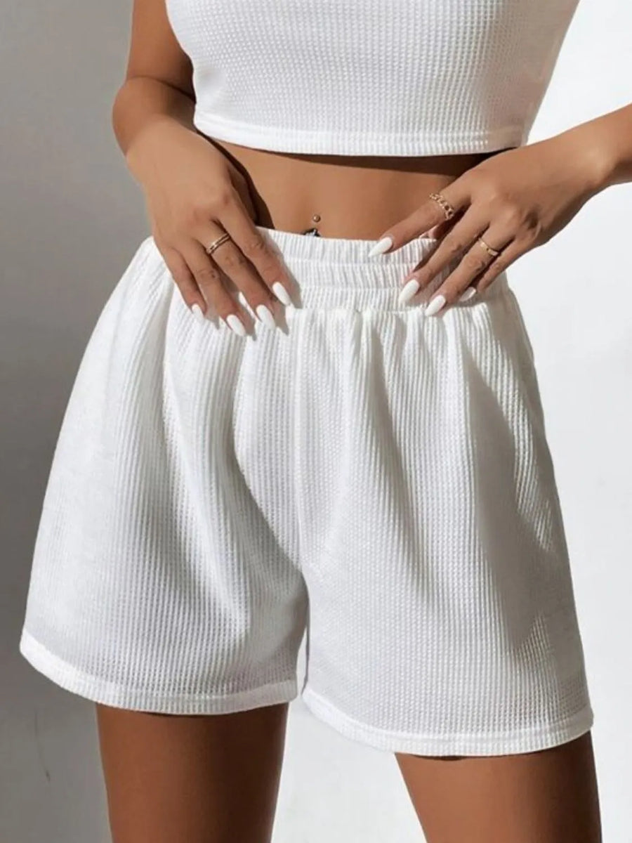 White ribbed knit crop top and high-waist shorts set with elastic waistband.
