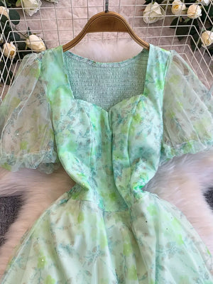 Green floral maxi dress with sweetheart neckline, smocked bodice, and puff sleeves.