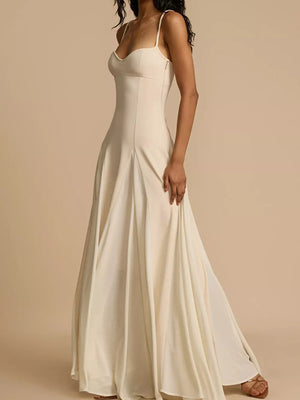 Elegant ivory sweetheart neck maxi dress with spaghetti straps and flowing skirt.
