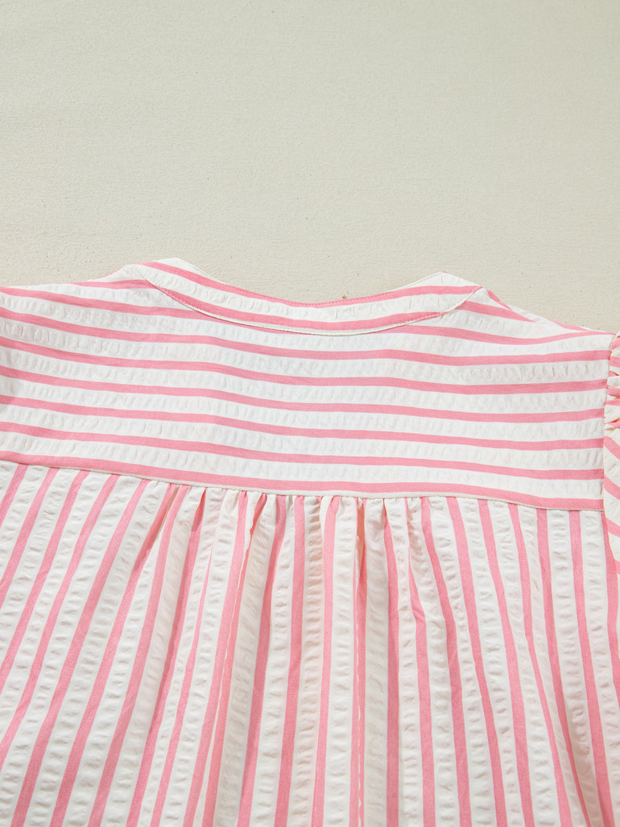 Pink and white striped textured blouse with gathered yoke and puff sleeves.
