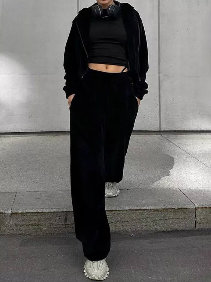 Black cropped zip hoodie and wide leg pants set with a black crop top.