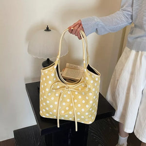 Yellow shoulder bag featuring bowknot detail and polka dot