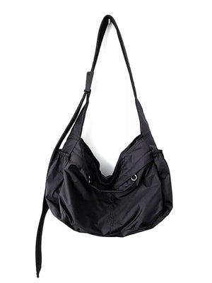 Black nylon casual crossbody bag with adjustable strap and metal grommets