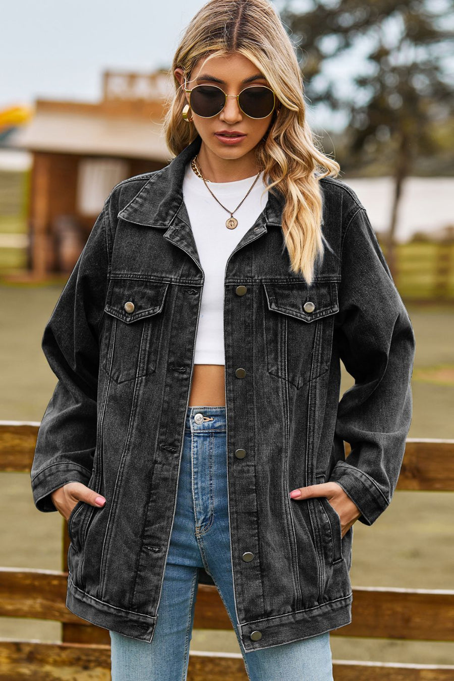 Black oversized denim trucker jacket with classic buttoned front and chest pockets.