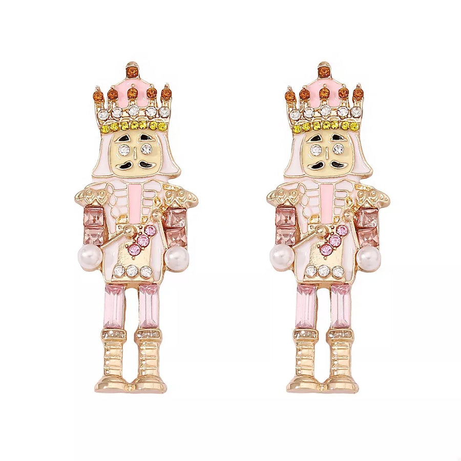 Blush pink nutcracker dangle earrings with crown and pearl details.