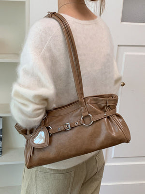 handbag in camel featuring decorative buckle and relaxed fit