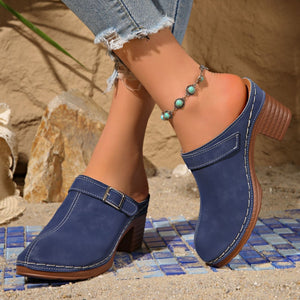 Blue round toe platform slip-ons with buckle detail and stacked heel.
