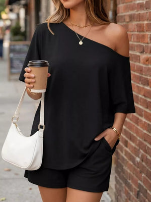 two-piece set in black featuring one-shoulder and relaxed fit