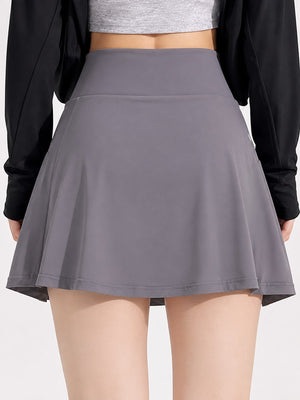 88% nylon, 12% spandex pleated skirt in Purple with flared silhouette