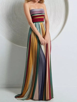 Vibrant striped strapless maxi dress with a pleated skirt and flowing silhouette.