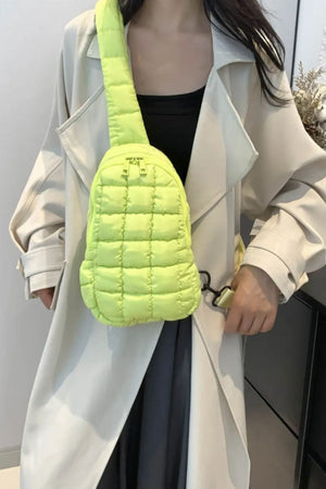 Padded sling bag in Yellow Green with quilted texture and top handle.