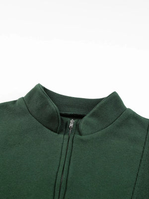 Dark green half zip sweatshirt with stand collar and ribbed details.