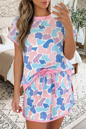 Pastel camouflage athletic two-piece set with crew neck top and drawstring shorts.