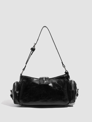 Black shoulder bag featuring rivet embellishment and crocodile-embossed