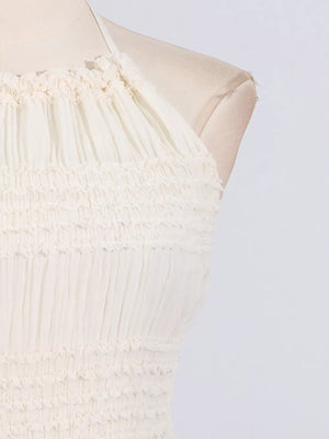 Textured white halter neck maxi maternity swim dress with smocked bodice detail.