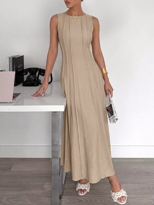 Beige textured maxi dress with elegant silhouette, sleeveless, round neck, and vertical seam details.
