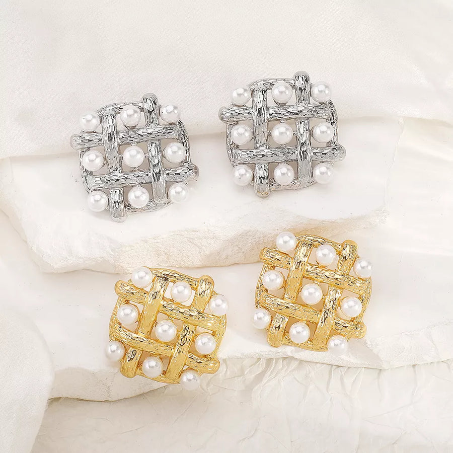 silver earrings featuring square shape and grid